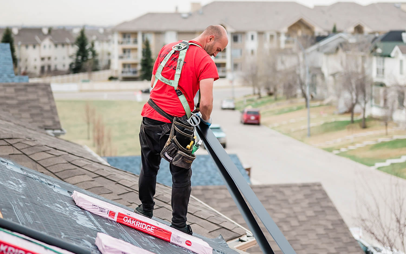 Photo of our roofer installing a new roof to a Calgary home