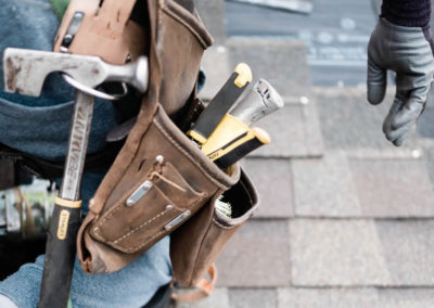 Up close photo of our roofer's tool belt