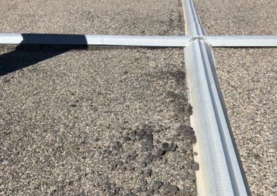 Photo of a flat roof with gravel in a Calgary industrial area