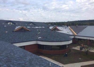 Another photo of a large commercial asphalt roof being installed