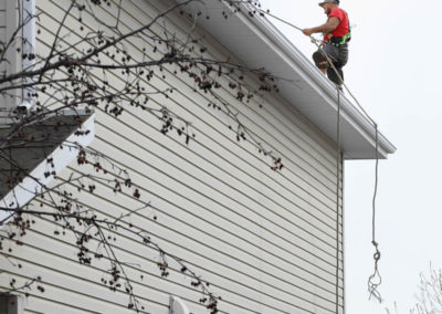 Photo of our roofer installing a new roof on a Calgary home