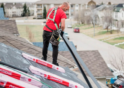 Photo of one of our roofers installing a new asphalt residential roof