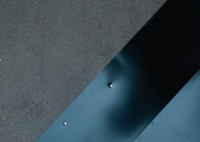 Close up photo of our roofing underlay, starter stripping, and plywood roof base