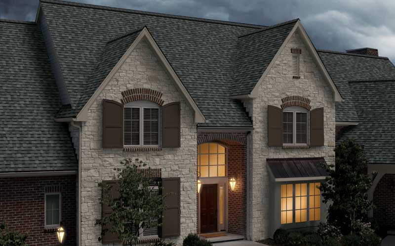 Computer rendered image of a large brick Calgary home with Owens Corning's TruDefinition Duration STORM Shingles installed