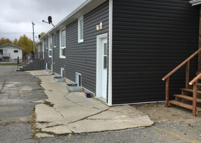 Photo of new vinyl siding on the back side of a Calgary dual zoned building