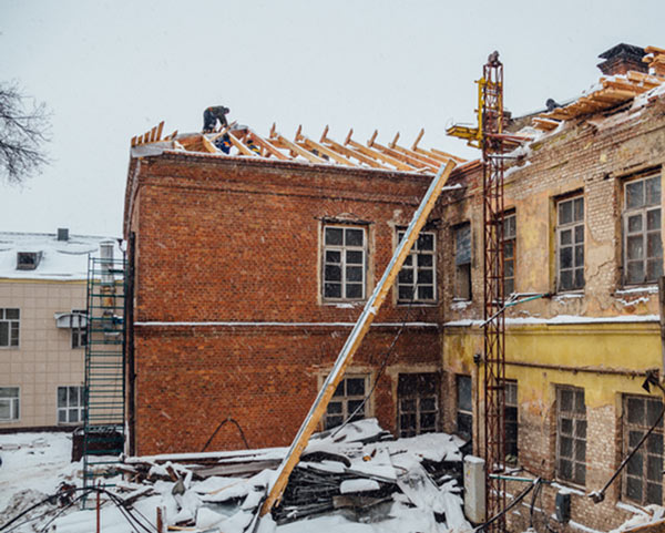 Photo of an Edmonton heritage building's roof being replaced in winter
