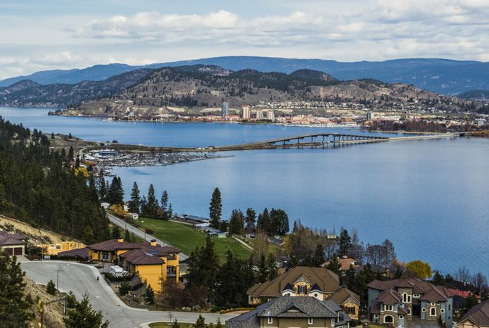 Photo of Kelowna houses' roofs with background lake