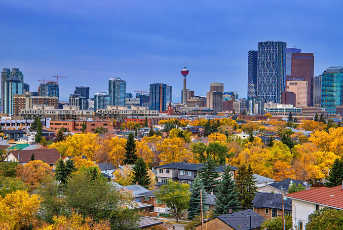 Photo of Calgary with houses' roofs in foreground