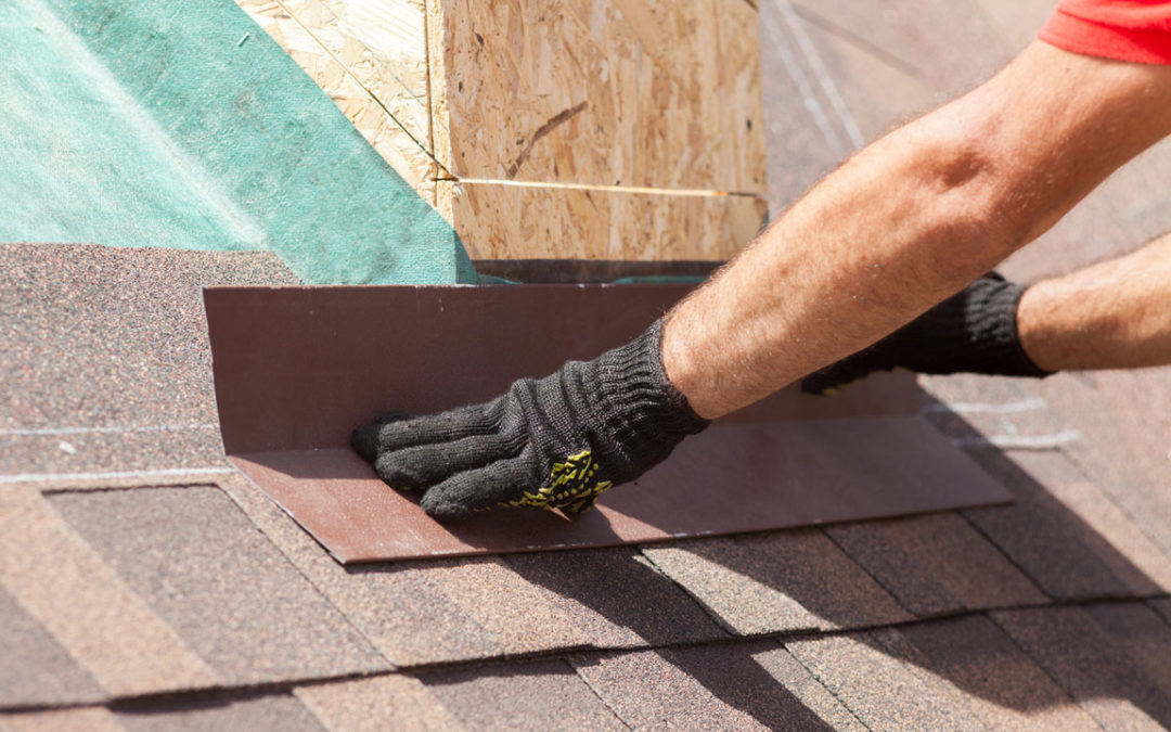 Roofer installing an ice shield on a new skylight